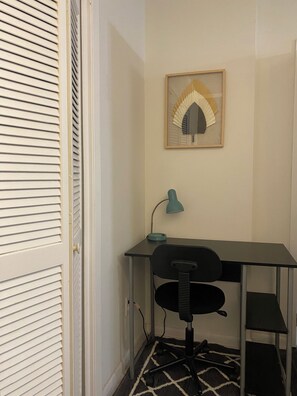 A small, neatly arranged workspace with a desk, chair, and a framed picture on the wall. - Magnolia Suite Vacation Home -Private Entry, Old Canton N. Jackson (Jackson)