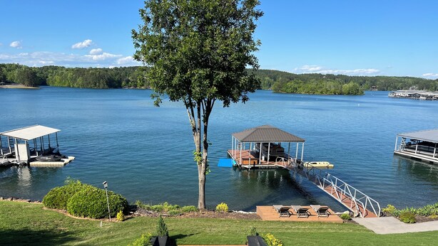 A lakeside property with a gazebo, dock, and outdoor seating area. - Lake Paradise  (Six Mile)