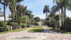 Stroll along the beautifully maintained garden pathway to the entrance of this modern building.