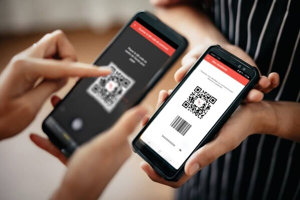 Two smartphones displaying QR codes.