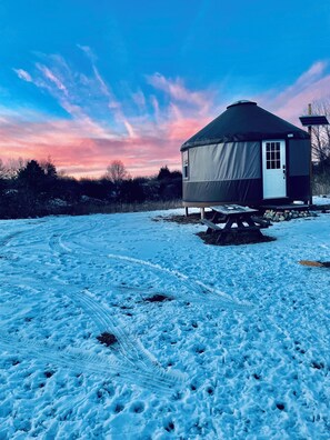 A snow-covered landscape with a yurt-style tent structure. - Off the Grid Yurt Camping (Jackson)