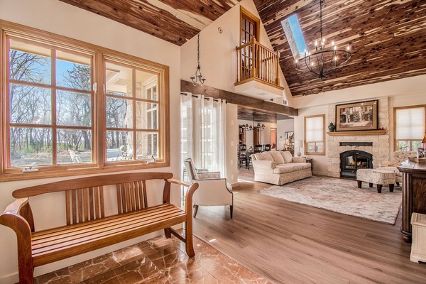 Exquisite foyer great room cathedral clgs cedar lined open and bright.