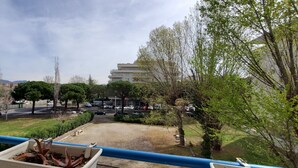 A balcony with potted plants, a view of a parking lot, and a building in the background. - Fréjus Plage, Le Sextant, Large T2 of 52m2, 3/4 people, swimming pool, large balcony, WIFIair-conditioned living room, 400m from the beach (Fréjus)