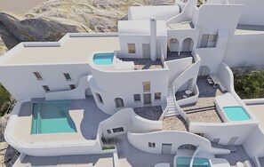 Un edificio moderno y blanco con varias piscinas y zonas de estar al aire libre.