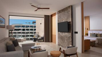 A modern living room with a sofa, chairs, a coffee table, and a TV mounted on a textured wall.