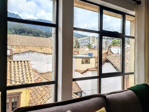 Enjoy breathtaking views of the surrounding mountains and cityscape from this room's large window.