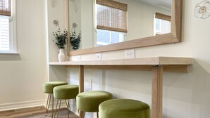 A room with a wooden vanity, a mirror, and three green stools. - Coastal Chic Home on the Island of Cape May  (Cape May)