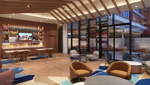 Een modern interieur met een bar, zitplaatsen en uitzicht door grote ramen.
