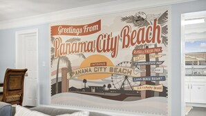 A wall mural depicting Panama City Beach with landmarks like Russell Fields Pier and Long Beach Resort. - Steps to Beach! |Sleeps 11!| Summer Ready! (Panama City)