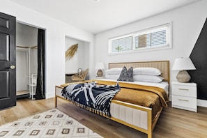 A bedroom with a bed, bedside tables, a window, and a door. - NEW Heated Pool King bed Tulum inspired Home (Scottsdale)