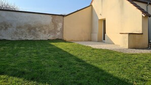 A building with a sloped roof and a small entrance.