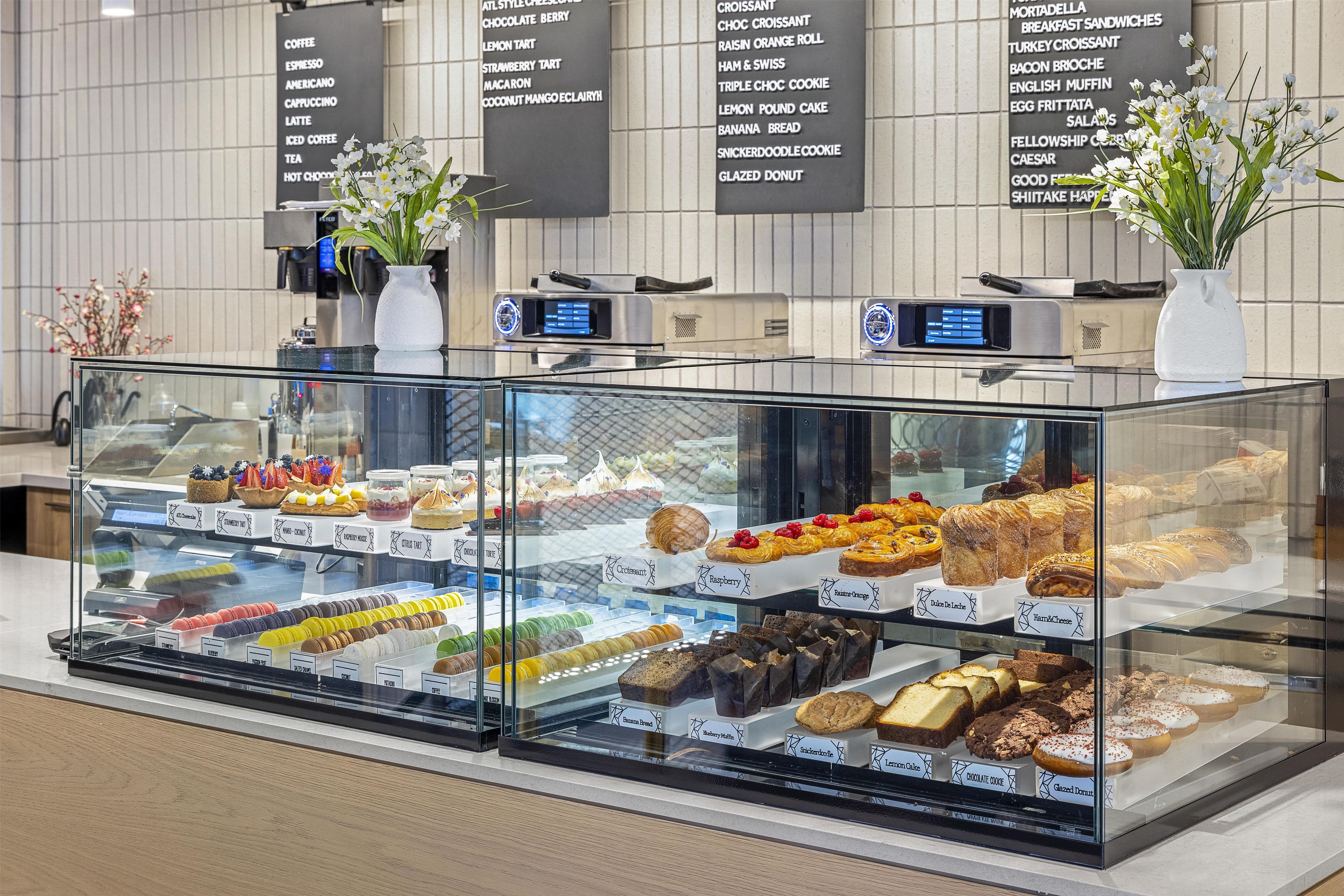 A bakery display case with various pastries and desserts.