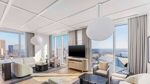 A modern hotel room with a large flat-screen TV, comfortable seating, and a city view. - Signia By Hilton Atlanta Georgia World Congress Center (Atlanta)