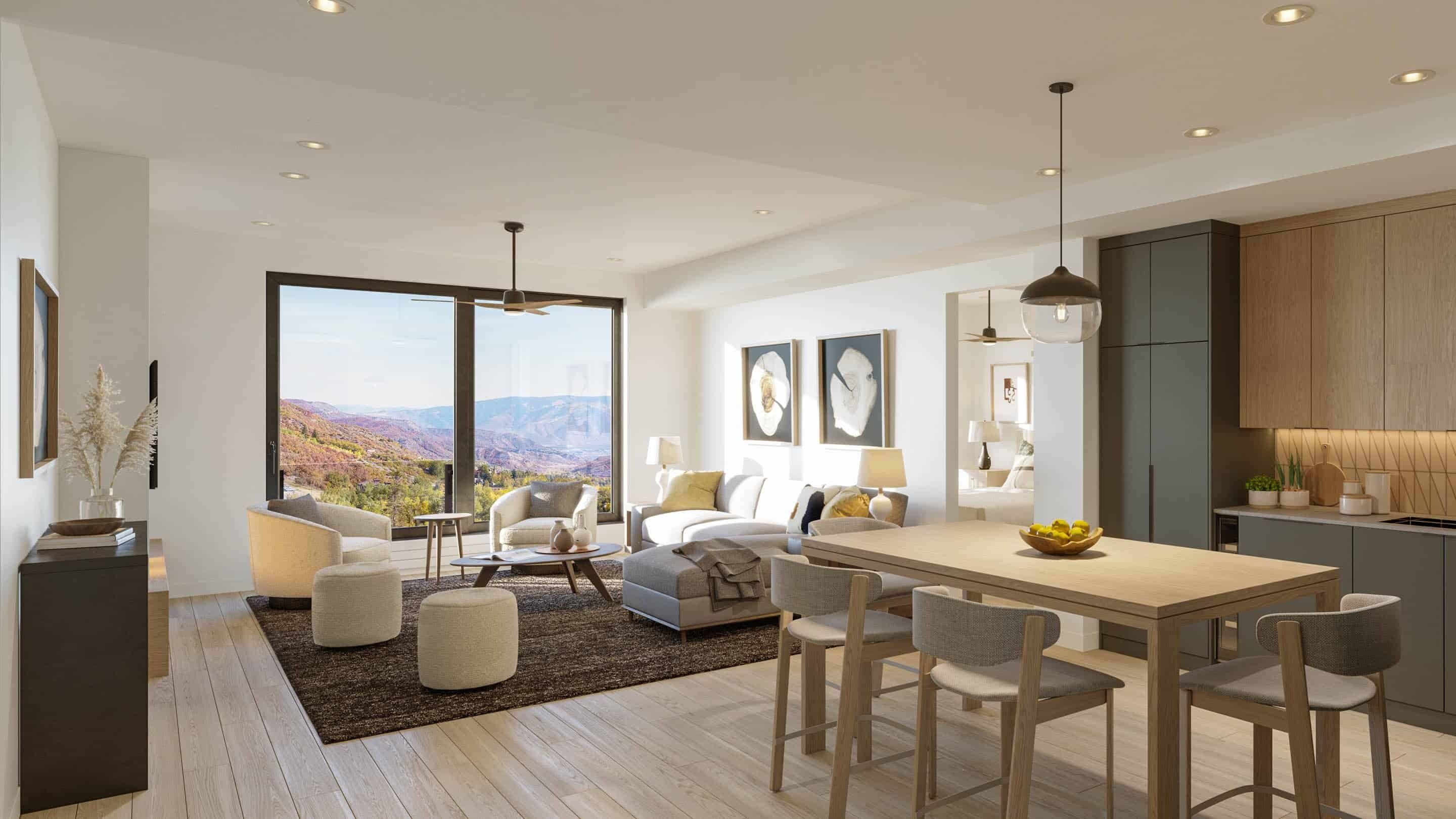 A modern kitchen with a dining area, large windows offering a scenic view, and a cozy seating area with a sofa and chairs.