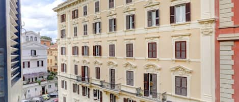 A multi-story building with a classical architectural style, featuring evenly spaced windows and balconies.