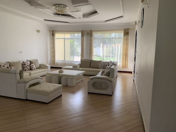 A spacious living room with a sectional sofa, a chaise lounge, and a coffee table.