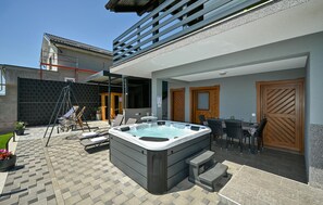 A spa area with a hot tub, outdoor seating, and a covered patio. - Pet friendly home in Veliko Trgovisce with sauna (Veliko Trgovisce)