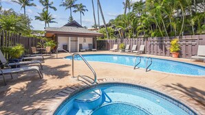 A swimming pool with lounge chairs and a small building, surrounded by palm trees. - LOW August   rates  A/C-Free Parking-No Resort Fees (Kihei)