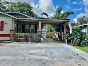 Home sweet home at 303, where a covered porch invites relaxation and a beautifully manicured yard offers a peaceful retreat.
