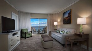Relax in a stylish room with a flat-screen TV, comfortable seating, and a large window offering a view of the sky.