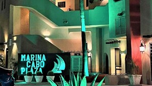 A multi-story building with a sign reading "MARINA CABO PLAZA". - New Remodel / Spanish Chic Suite on the Cabo Marina (Cabo San Lucas)