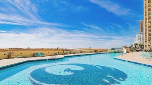 A swimming pool with a clear blue sky and a desert landscape in the background. - Phoenix VII 203 | Orange Beach, AL (Orange Beach)