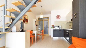 A modern kitchen with a dining area, a staircase, and a sofa. - Villa with pool near the beach (Banjole)