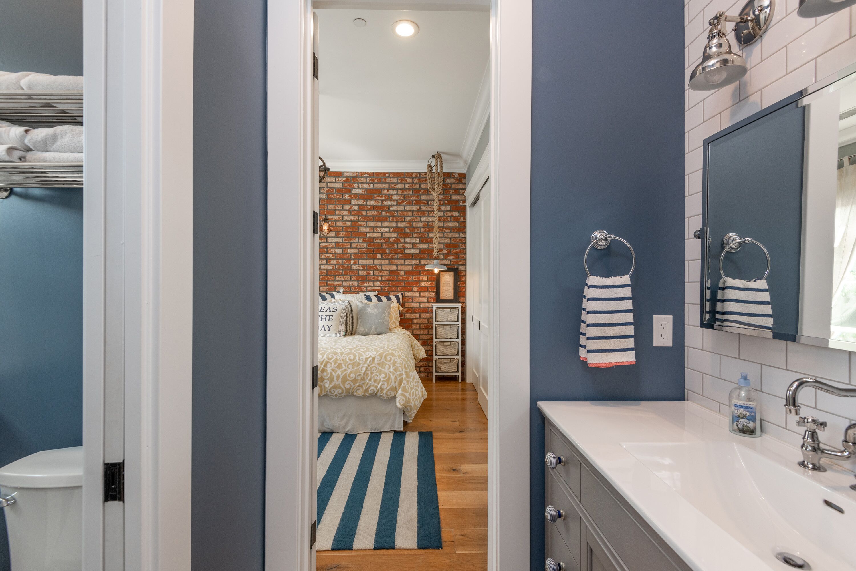 A modern bathroom with a white sink, a mirror, and a shower.