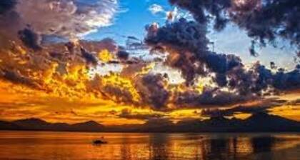 walkout basement has living room and dining room with table with a couch and tv.