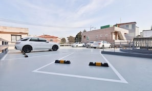 A parking area with multiple cars and bollards.