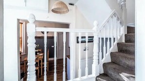 A staircase with white balusters leading to a landing. - The Boat House Sleeps 4 Pet Friendly (Dawlish)