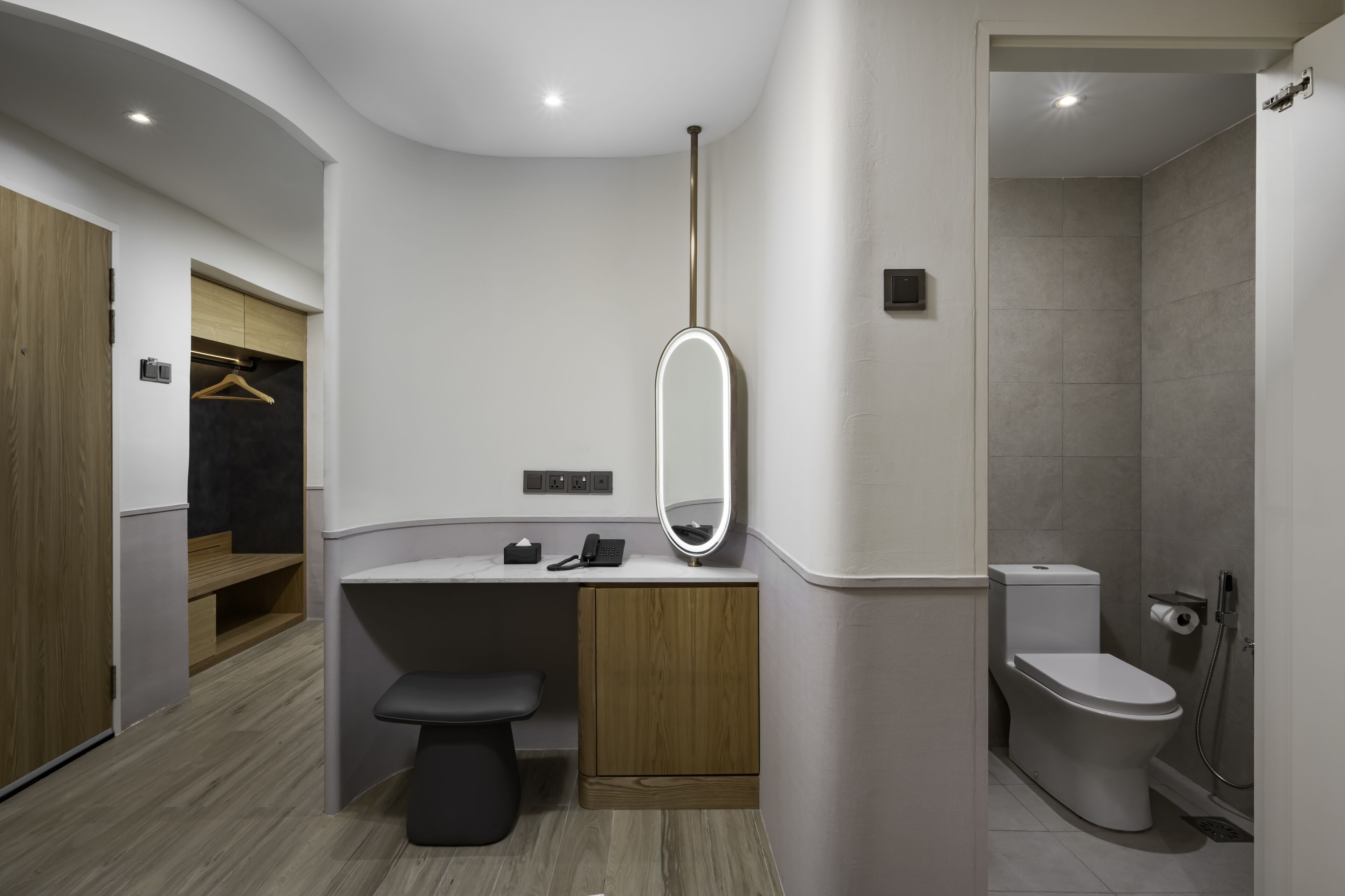 A modern bathroom with a vanity, toilet, and shower.
