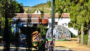 A garden with a white building, a dome structure, and a variety of plants. - Vacation Home 'El Rancho' with Mountain View, Pool, Wi-Fi & Garden (El Gastor)
