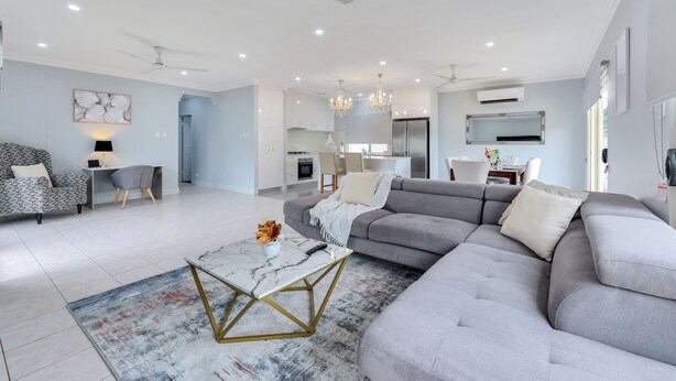A modern living room with a grey sectional sofa, a marble coffee table, and a patterned rug. - The OC Home: Centrally Located, Home Away Home (Coconut Grove)