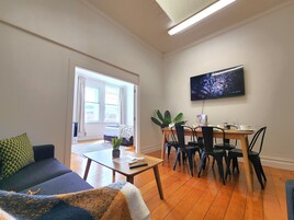 Signature Apartment | Living area | 55-inch Smart TV with cable channels, TV