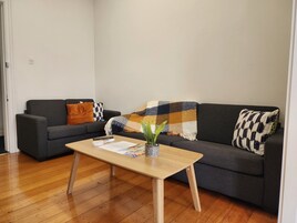 Signature Apartment | Living room | 55-inch Smart TV with cable channels, TV