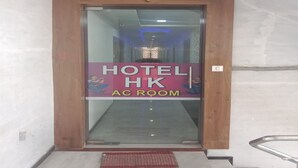 A hotel entrance with a sign indicating an AC room.