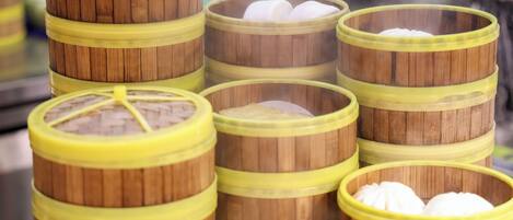 A stack of bamboo steamers with lids, likely used for cooking or serving food.