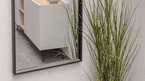 A modern room with a minimalist design, featuring a white desk, a large mirror, and a plant. - Zen Central Luxury Apartment (Heraklion)