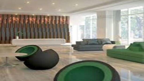 A modern interior with a seating area, a large window, and a decorative wall. - Green Residences  Taft (Manila)