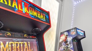 A gaming arcade with Mortal Kombat and NFL Blitz games.