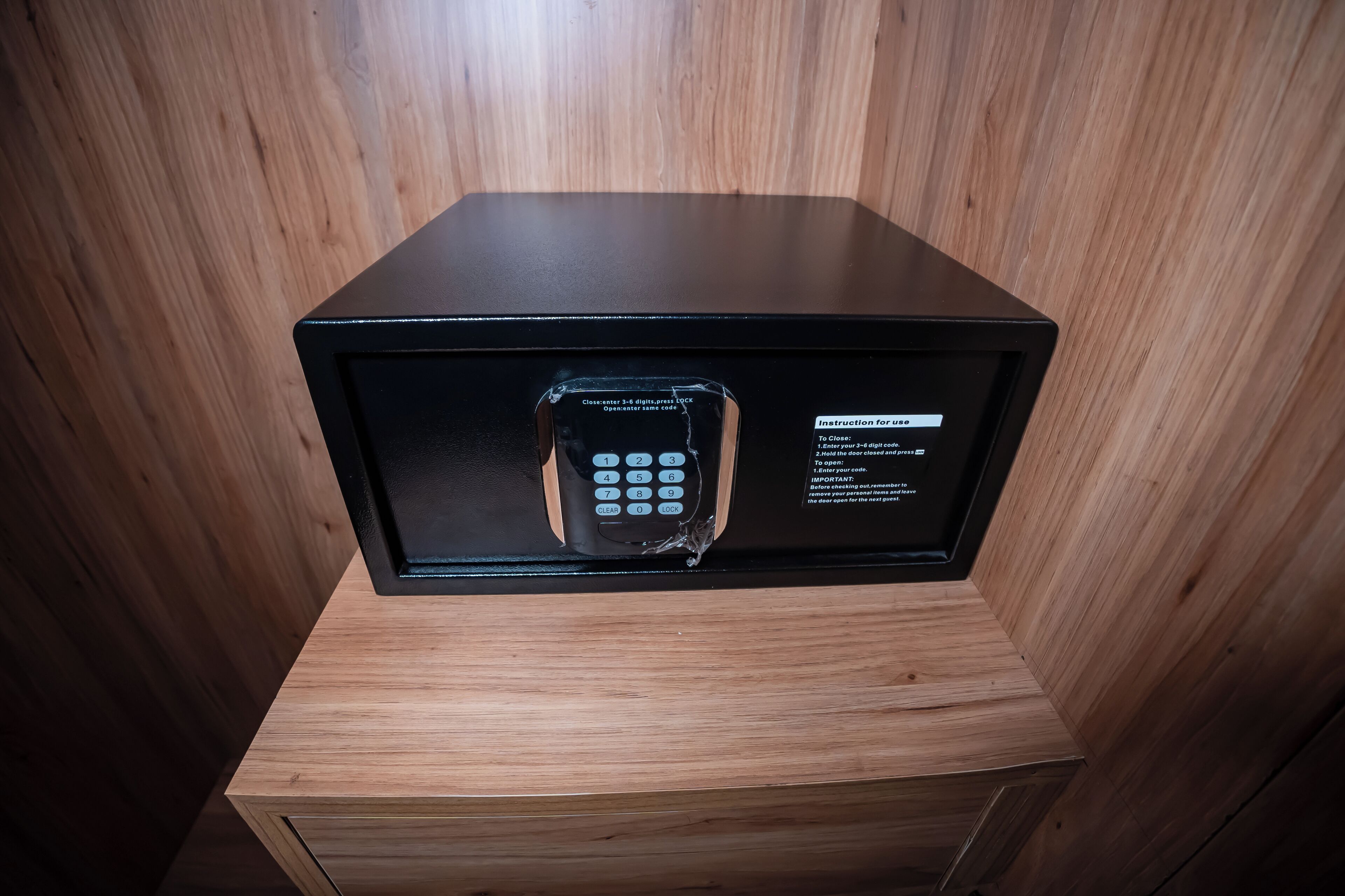 Microondas con pantalla digital y panel de control, ubicada dentro de una caja de madera.