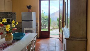 A kitchen with a refrigerator, a microwave, and a vase with flowers on the counter. - Tranquil Farmhouse in Umbria (Monte Santa Maria Tiberina)