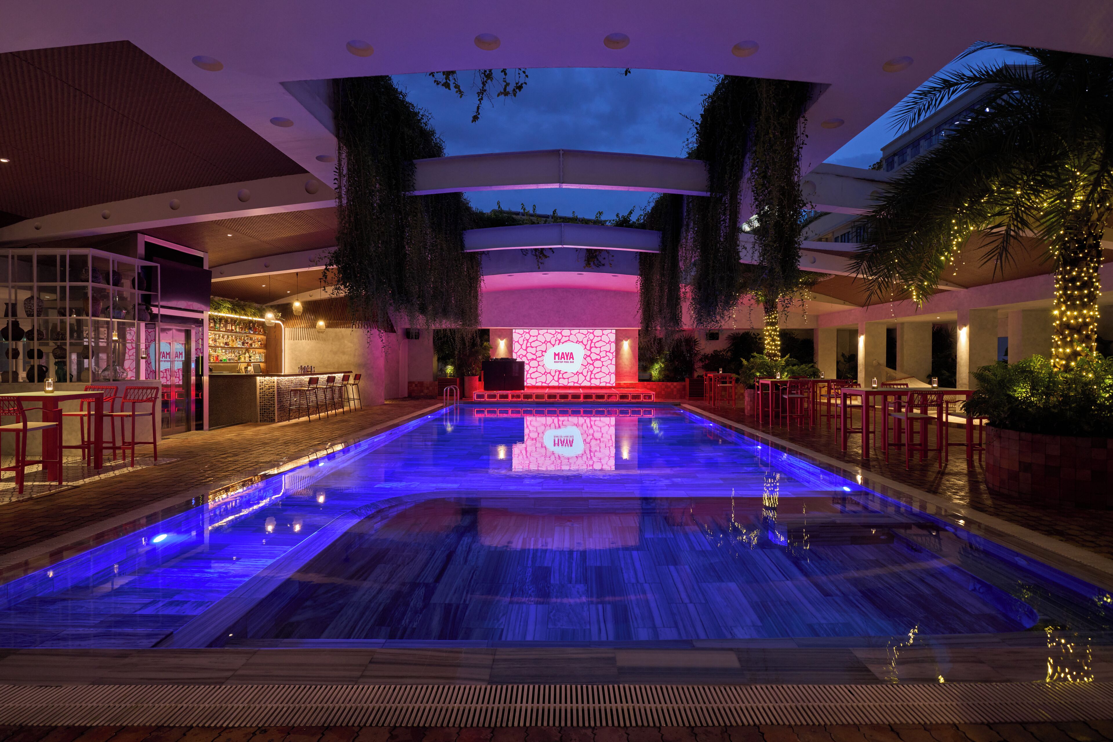 A swimming pool with a bar area and a seating section.