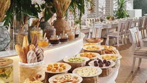 A buffet with various breads, pastries, and condiments. - Silverland Mây Hotel (Ho Chi Minh City)