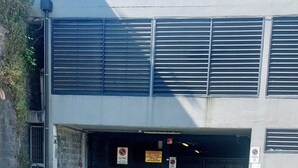 A building with a garage entrance, a no parking sign, and a no stopping sign. - SWEET HOME nice apartment near the marina (La Spezia)