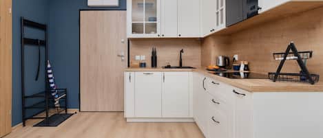 A wide-angle shot of the modern kitchen area, equipped with high-quality appliances and a spacious countertop.