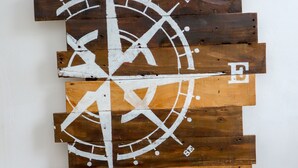 A wooden wall art piece with a compass design. - HOTEL ACRUS (Galle)