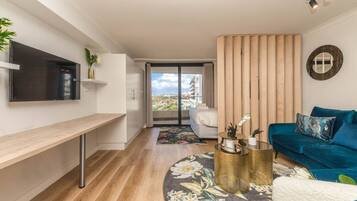 Basic Apartment, 1 Queen Bed | Living area | TV