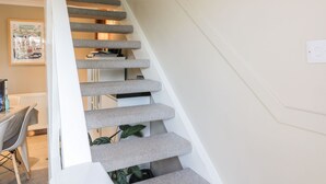 A staircase with multiple steps, each with a textured carpet. - Millbrook Cottage (Dalbeattie)